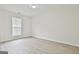 Empty bedroom with lots of light, neutral walls, and wood-look floors at 122 Claxton Ct, Jonesboro, GA 30238