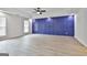 Bright bedroom featuring a navy accent wall, and hardwood floors at 122 Claxton Ct, Jonesboro, GA 30238