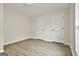 Bedroom featuring two large windows, neutral walls, and wood-look floors at 122 Claxton Ct, Jonesboro, GA 30238