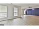 Spacious bonus room featuring a navy accent wall and hardwood floors at 122 Claxton Ct, Jonesboro, GA 30238
