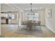 Dining room with modern chandelier, wood-style flooring, and large window at 122 Claxton Ct, Jonesboro, GA 30238