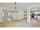 Open floor plan with dining room, wood-style flooring, and modern chandelier at 122 Claxton Ct, Jonesboro, GA 30238
