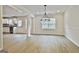 Dining room with modern chandelier, wood-style flooring, open floor plan at 122 Claxton Ct, Jonesboro, GA 30238