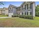 Two-story home with a well-manicured lawn and a driveway leading to a two-car garage at 122 Claxton Ct, Jonesboro, GA 30238