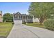 Charming two-story home with a well-manicured lawn and a long driveway leading to a two-car garage at 122 Claxton Ct, Jonesboro, GA 30238