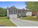 Two-story home with a well-manicured lawn and a driveway leading to a two-car garage at 122 Claxton Ct, Jonesboro, GA 30238