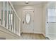 Foyer showcasing a white front door with glass window and stairs with white wood trim at 122 Claxton Ct, Jonesboro, GA 30238