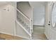 Foyer features a staircase with carpeted steps and wood-look flooring at 122 Claxton Ct, Jonesboro, GA 30238