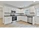 Clean kitchen featuring granite countertops, stainless steel appliances, and white cabinetry at 122 Claxton Ct, Jonesboro, GA 30238