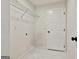 Neat laundry room equipped with wire shelving and a white door at 122 Claxton Ct, Jonesboro, GA 30238