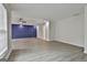 Spacious living room featuring modern blue paneling and wood-look floors at 122 Claxton Ct, Jonesboro, GA 30238