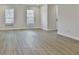 Open-concept living room with wood floors and plenty of natural light at 122 Claxton Ct, Jonesboro, GA 30238