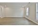 Spacious living room with light hardwood floors, white trim and neutral walls at 122 Claxton Ct, Jonesboro, GA 30238