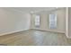 The living room offers ample natural light, hardwood floors and a neutral color palette at 122 Claxton Ct, Jonesboro, GA 30238
