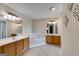 Bright bathroom with double vanities, a soaking tub, and white trim at 7115 Secret Rose, Douglasville, GA 30134
