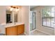 Bright bathroom featuring a vanity with sink and a shower with glass door at 7115 Secret Rose, Douglasville, GA 30134