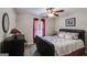 Well-lit bedroom with hardwood floors, queen-sized bed and a window with red blinds at 7115 Secret Rose, Douglasville, GA 30134