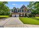 Beautiful two-story home with a well-manicured lawn, two-car garage and a brick and siding exterior at 7115 Secret Rose, Douglasville, GA 30134