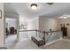 Upstairs hallway with carpeting and railings, featuring a seating bench at 7115 Secret Rose, Douglasville, GA 30134