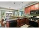 Well-lit kitchen features wood cabinets, stainless steel appliances, and a double basin sink at 7115 Secret Rose, Douglasville, GA 30134