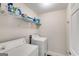 Bright laundry room features a washer, dryer, and storage shelving at 7115 Secret Rose, Douglasville, GA 30134