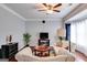Cozy living room boasts hardwood floors, two sofas, and a ceiling fan at 7115 Secret Rose, Douglasville, GA 30134