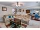 Inviting living room with a large sectional sofa, wooden coffee table, and open access to the kitchen at 7115 Secret Rose, Douglasville, GA 30134