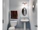 Stylish powder room featuring a pedestal sink, modern lighting, and sleek fixtures at 7115 Secret Rose, Douglasville, GA 30134