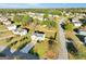 Aerial view showcases a well-kept white home with a fenced backyard, surrounded by lush green lawns and mature trees at 5284 Benjamin Trl, Ellenwood, GA 30294