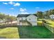 A spacious backyard with a wooden fence, lush grass, and a charming deck, perfect for outdoor enjoyment at 5284 Benjamin Trl, Ellenwood, GA 30294