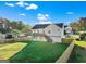 Aerial view of a house with a fenced backyard, complemented by lush greenery and a private wooden deck at 5284 Benjamin Trl, Ellenwood, GA 30294