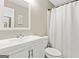 Bright bathroom featuring a vanity with white countertops, framed mirror, and shower with white curtain at 5284 Benjamin Trl, Ellenwood, GA 30294