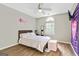 A cozy bedroom with wood flooring, decorated with a colorful accent wall, comfortable bed and bright natural light at 5284 Benjamin Trl, Ellenwood, GA 30294