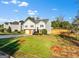 Charming two-story home features a well-manicured lawn, mature landscaping, and a welcoming entrance at 5284 Benjamin Trl, Ellenwood, GA 30294