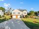 Well-maintained two-story home features an attached two-car garage, brick veneer, and a long driveway at 5284 Benjamin Trl, Ellenwood, GA 30294