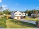This home has an attached two-car garage, and a long driveway, with mature landscaping at 5284 Benjamin Trl, Ellenwood, GA 30294