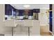 This kitchen features sleek blue cabinets, stainless steel appliances, and bar-style seating at 5284 Benjamin Trl, Ellenwood, GA 30294