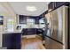 This kitchen features dark blue cabinets, stainless steel appliances, and marble countertops at 5284 Benjamin Trl, Ellenwood, GA 30294