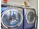 This laundry room features new GE washer and dryer, with convenient wire shelving for ample storage at 5284 Benjamin Trl, Ellenwood, GA 30294