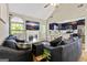 Open-concept living room with hardwood flooring, a fireplace, and a ceiling fan at 5284 Benjamin Trl, Ellenwood, GA 30294