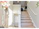 Entry staircase showcases modern design with light wood steps, white risers, and natural light at 5284 Benjamin Trl, Ellenwood, GA 30294