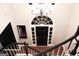 View from the top of a staircase facing a front door with large arched window and decorative chandelier above at 232 Spalding Gates Drive, Atlanta, GA 30328