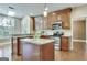 Spacious kitchen with custom wood cabinets, stainless steel appliances, granite countertops, and a center island at 232 Spalding Gates Drive, Atlanta, GA 30328