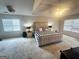 Bright main bedroom featuring neutral carpet, a tray ceiling, and large windows providing ample natural light at 232 Spalding Gates Drive, Atlanta, GA 30328