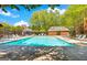 Community pool surrounded by lounge chairs and greenery at 232 Spalding Gates Drive, Atlanta, GA 30328