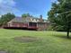 Expansive backyard with a large wooden deck and a brick home exterior, perfect for outdoor entertaining at 2451 Old Salem Se Cir, Conyers, GA 30013