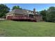 The backyard has a large wooden deck and a screened-in porch on a beautiful lawn and landscaping at 2451 Old Salem Se Cir, Conyers, GA 30013