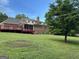 Spacious backyard features a large deck and established landscaping, backing up to the brick home at 2451 Old Salem Se Cir, Conyers, GA 30013