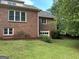 Beautifully maintained backyard with mature trees, lush lawn, and access to the brick home garage at 2451 Old Salem Se Cir, Conyers, GA 30013