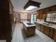 Charming kitchen features an island cooktop, stainless appliances, and wood cabinetry at 2451 Old Salem Se Cir, Conyers, GA 30013
